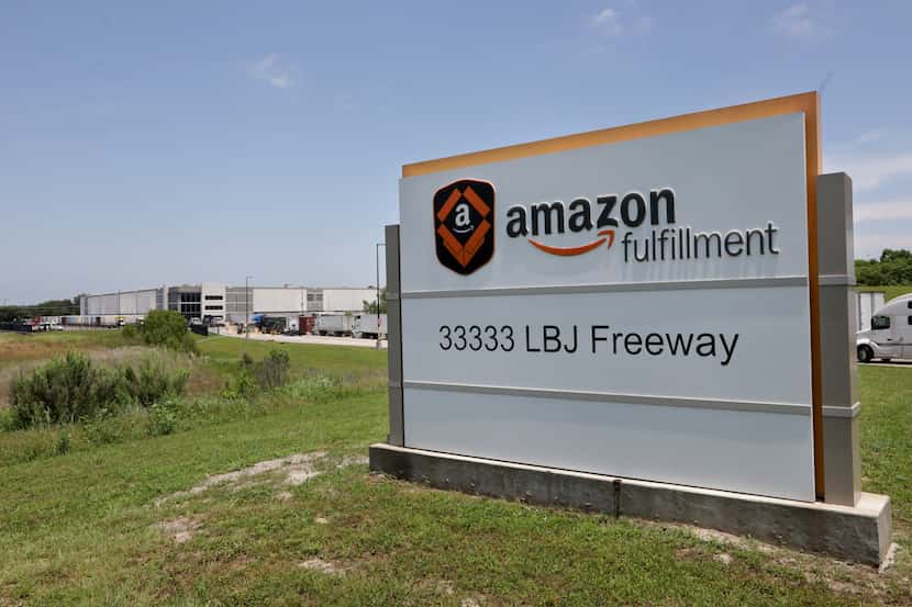Delivery trucks wait to enter an Amazon Fulfillment Center in South Dallas in June.