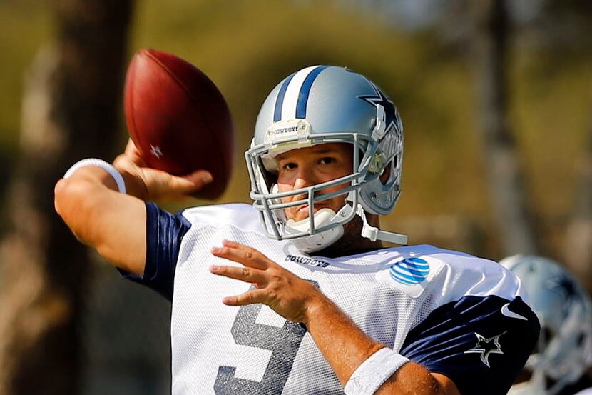 Dallas Cowboys quarterback Tony Romo (9) throws during afternoon practice at training camp...