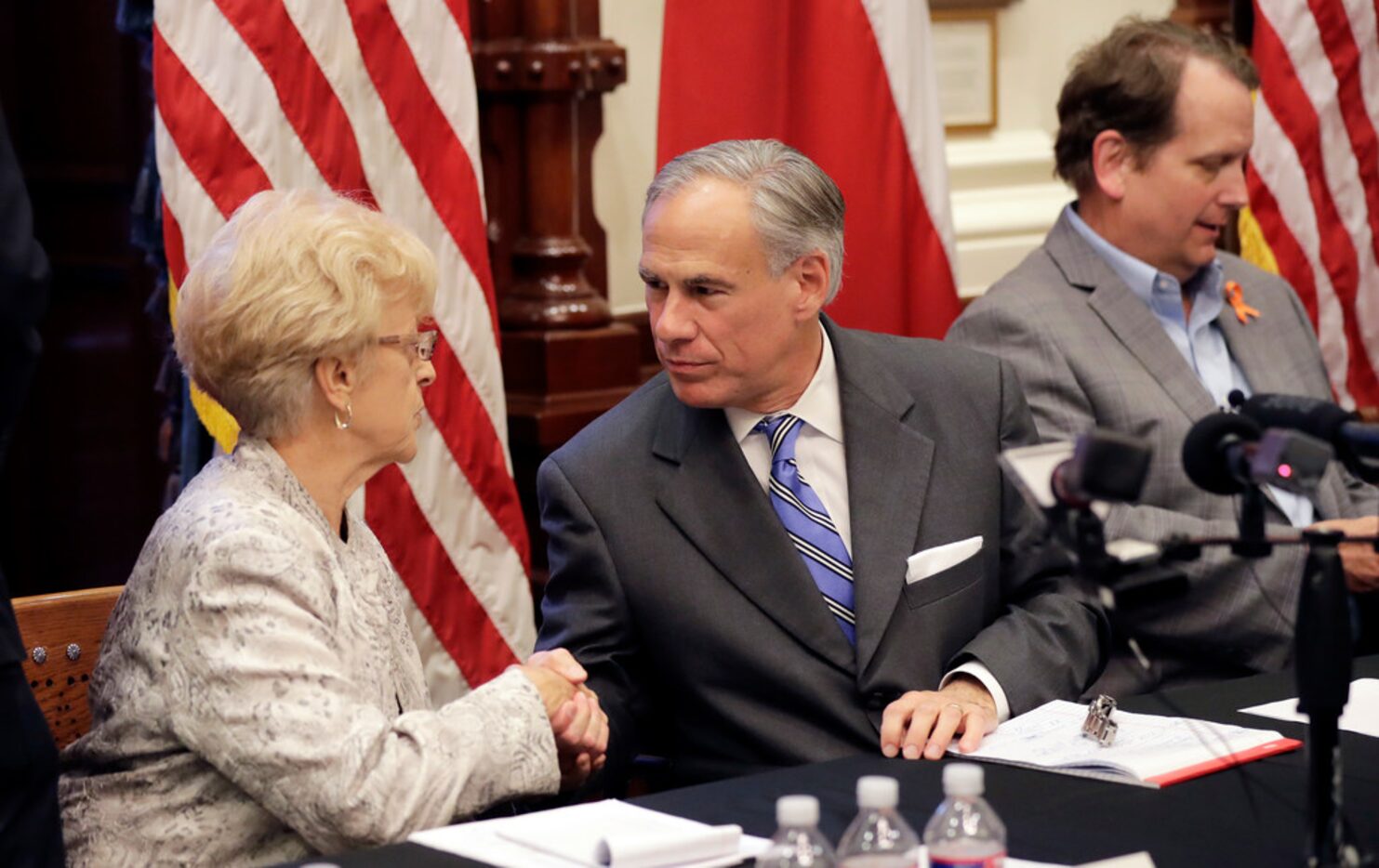 Alice Tripp, Legislative Director of the Texas State Rifle Association, left, shakes hand...