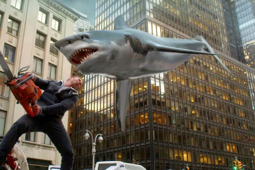 In this image released by Syfy, Ian Ziering, as Fin Shepard, battles a shark on a New York...