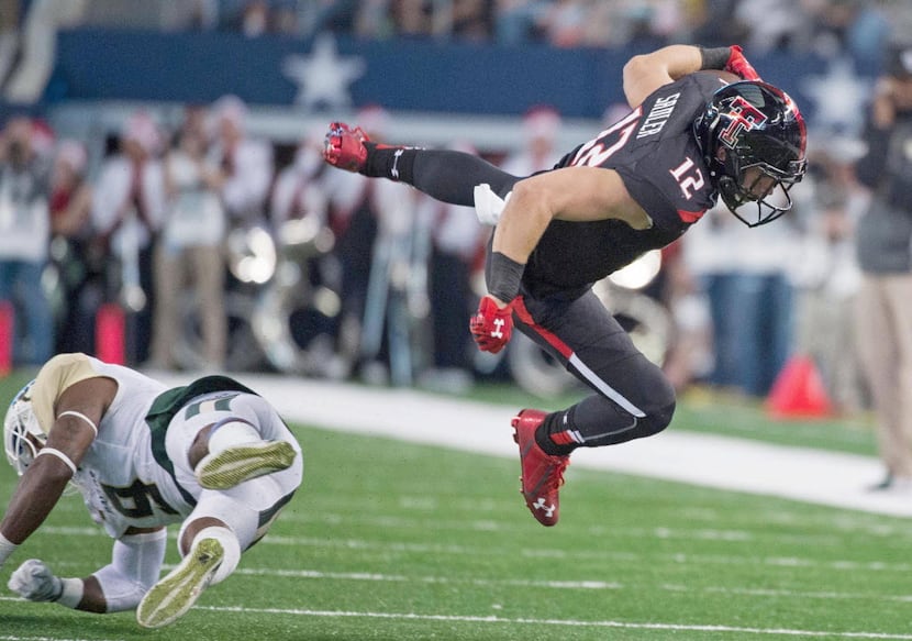 Nov 29, 2014; Arlington, TX, USA; Texas Tech Red Raiders wide receiver Ian Sadler (12) leaps...