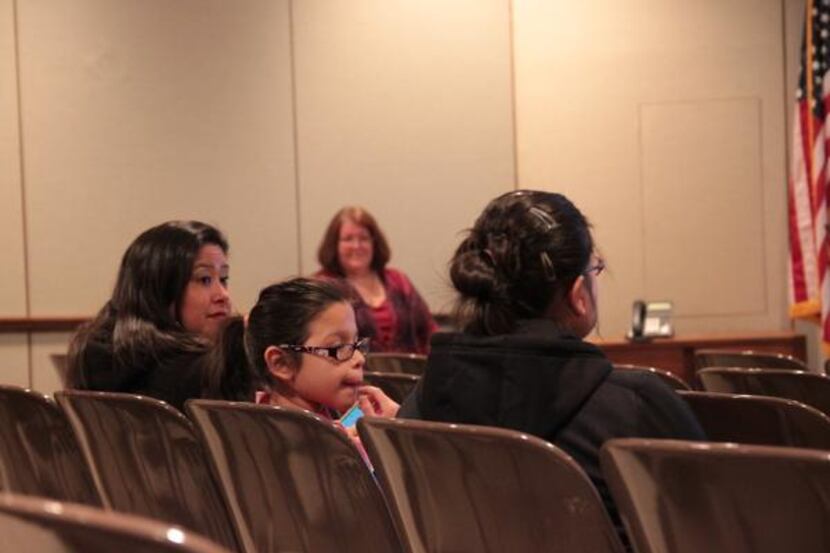 
Elizabeth Morales (from left), Sydney Colon and Elisa Morales listen for information about...