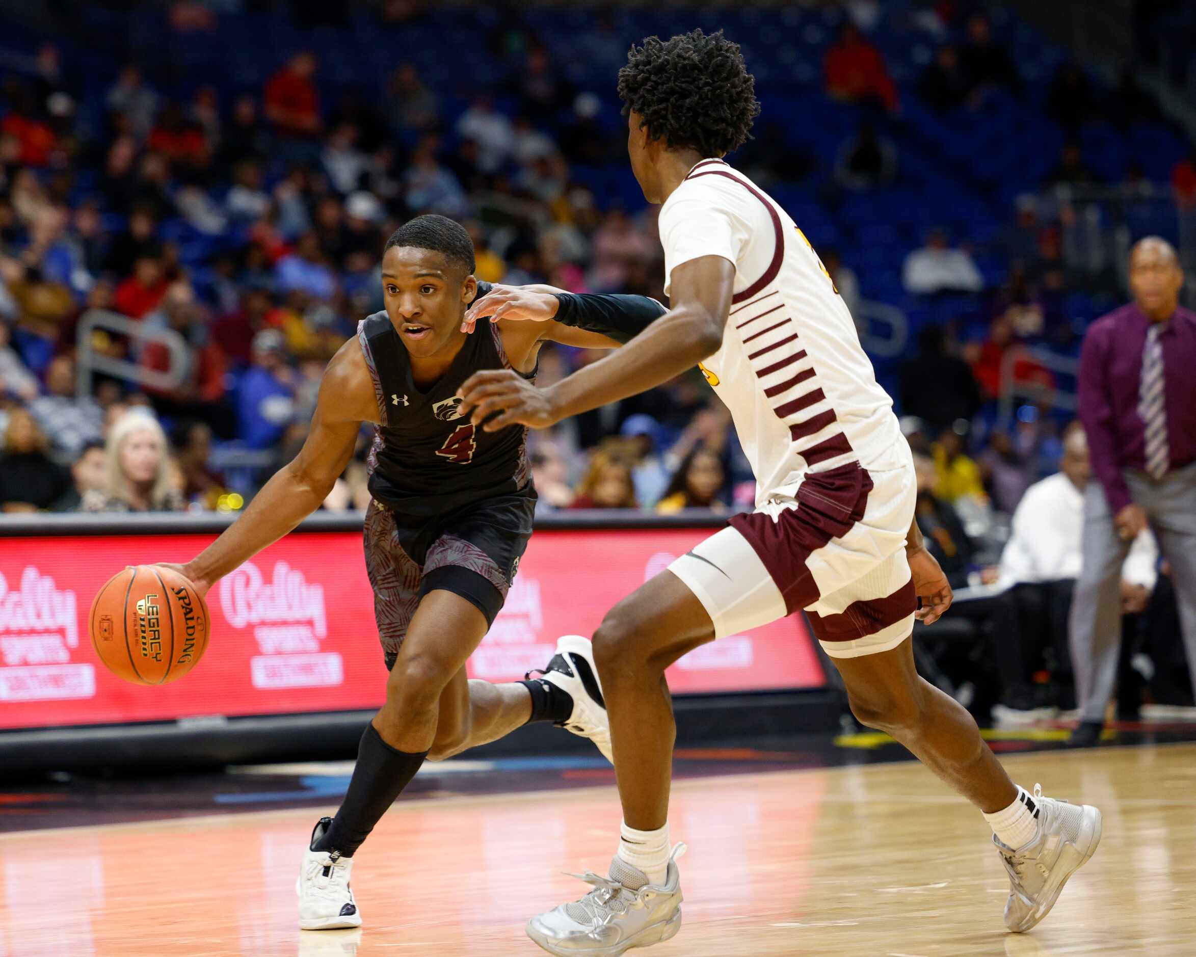 Mansfield Timberview guard Donovan O'Day (4) dribbles around Beaumont United forward...