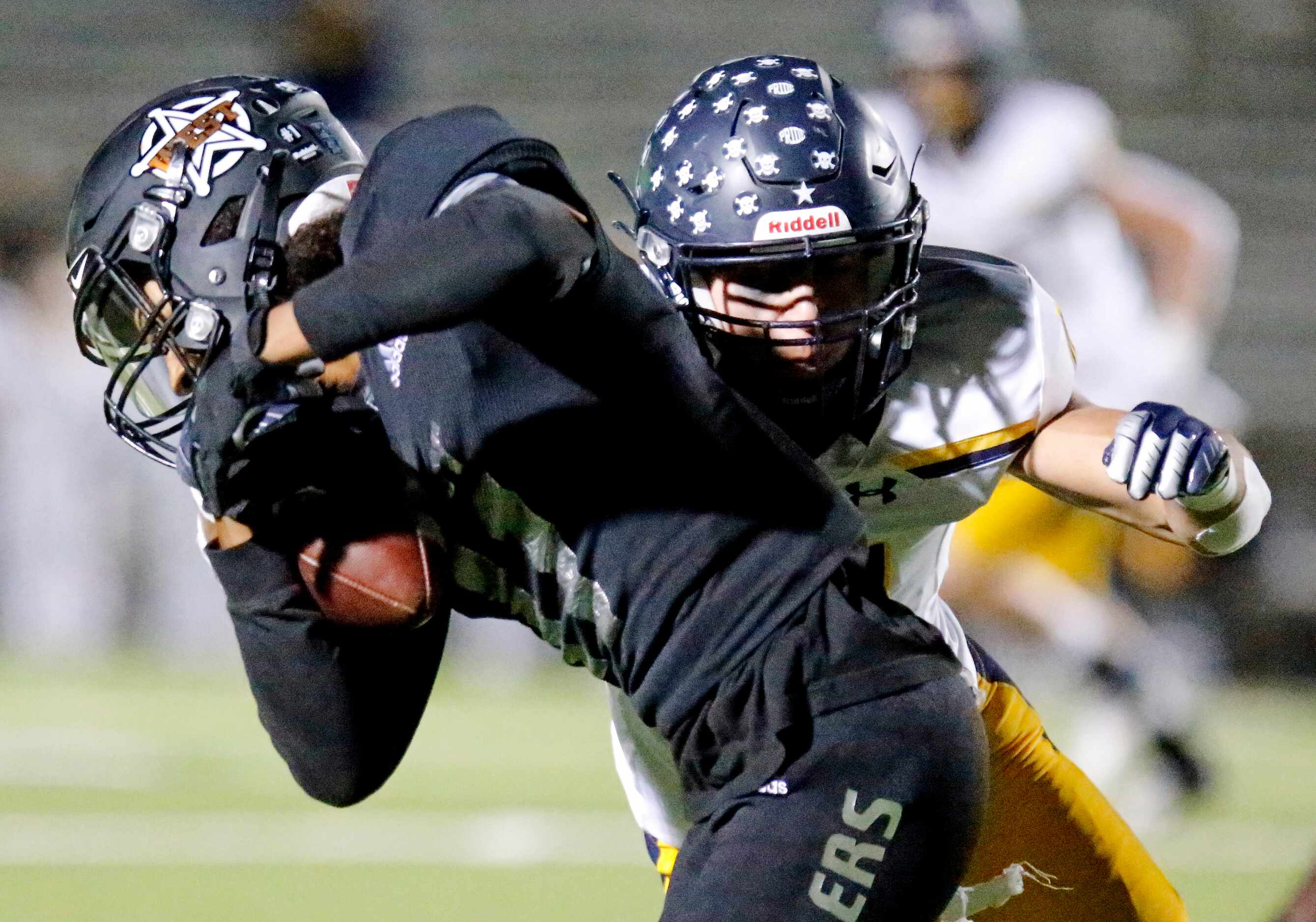 West Mesquite High School wide receiver Gabriel Corona (11) is tackled by Highland Park High...