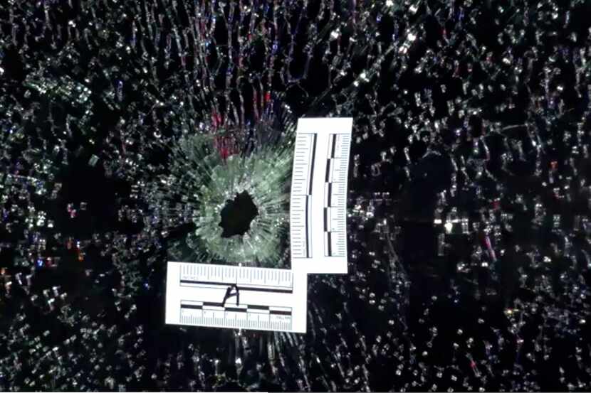 Evidence markers show where a bullet fired by Farmers Branch police Officer Michael Dunn...