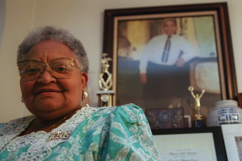  Mamie Till-Mobley stands before a portrait of her slain son, Emmett Till, in her Chicago...