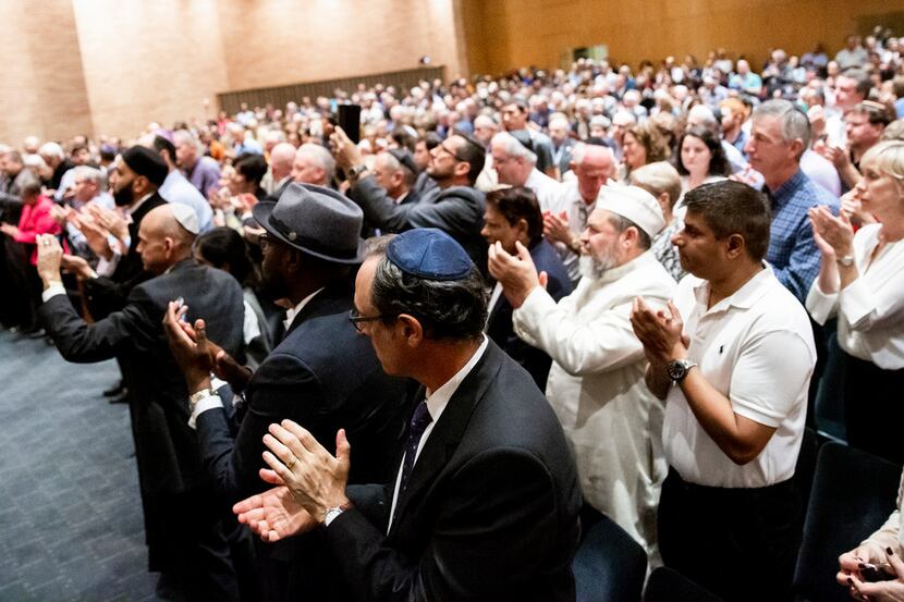 Attendees give a standing ovation as Bradley Laye, president and CEO at the Jewish...