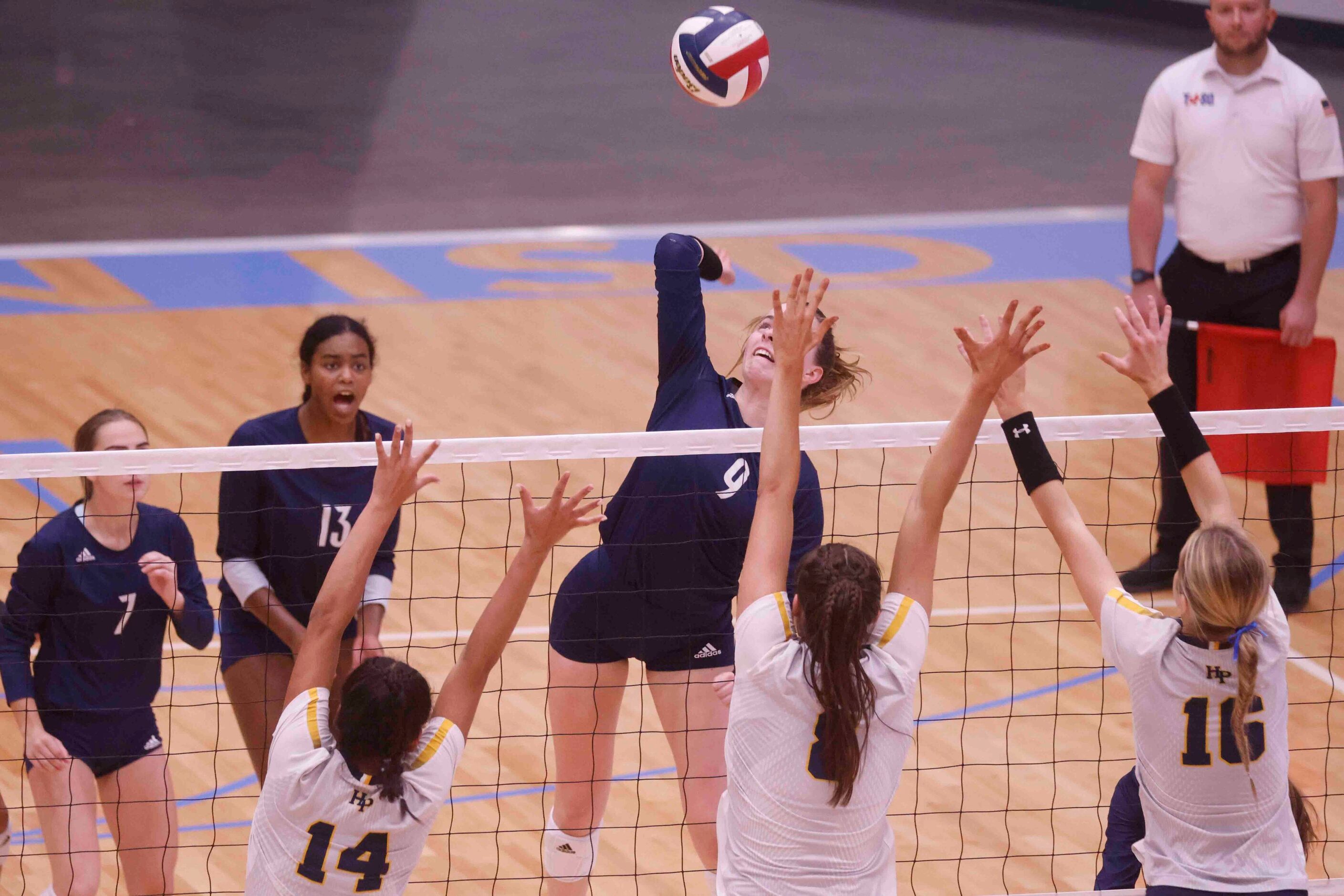 Flower Mound’s Cat Young (9) spikes the ball against Highland Park’s Bella Ocampo (14), Sec...