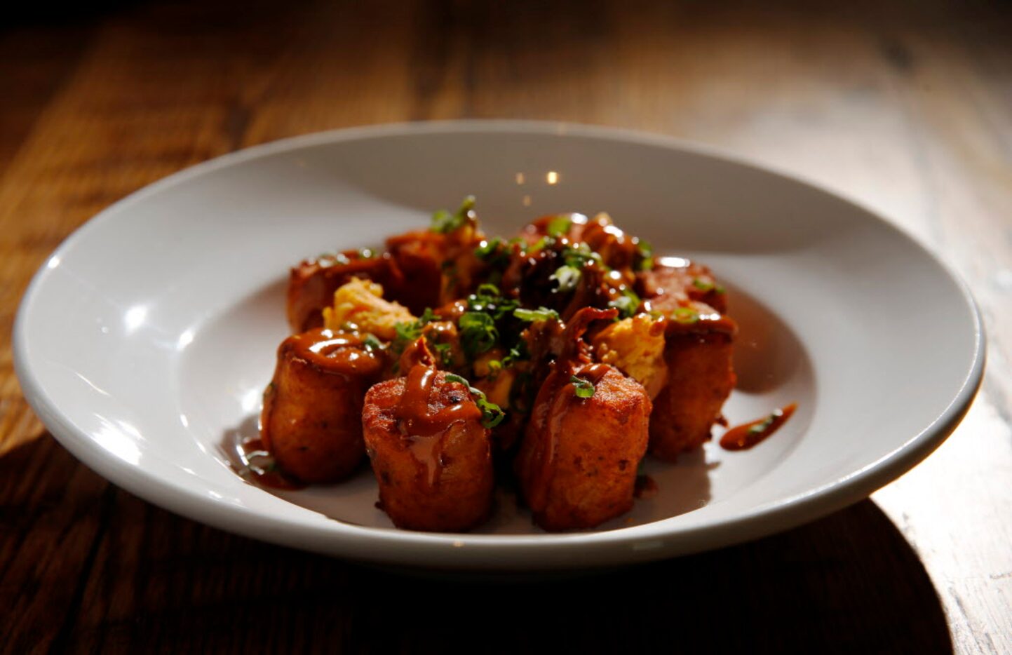 House-made potato tots with pulled pork, pimento cheese and barbecue aioli 