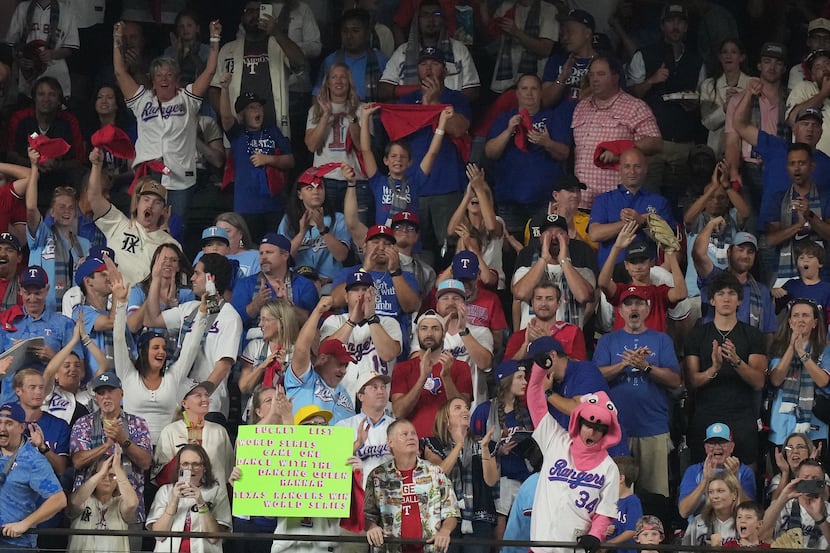 Texas Rangers fans cheer after starting pitcher Nathan Eovaldi struck out Arizona...