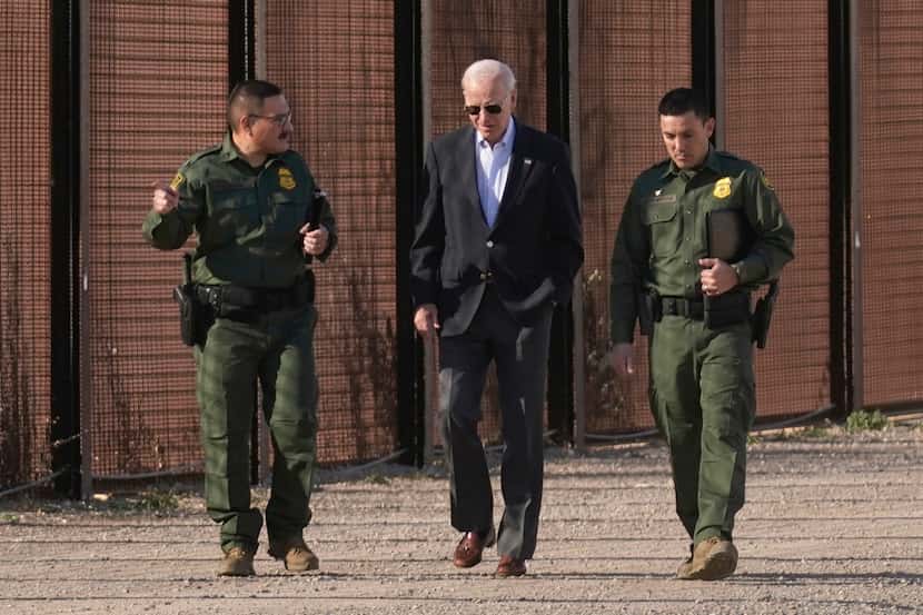 President Joe Biden walks with U.S. Border Patrol agents along a stretch of the U.S.-Mexico...