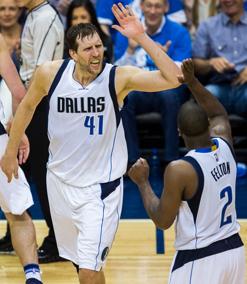 Dallas Mavericks forward Dirk Nowitzki (41) high-fives guard Raymond Felton (2) during the...