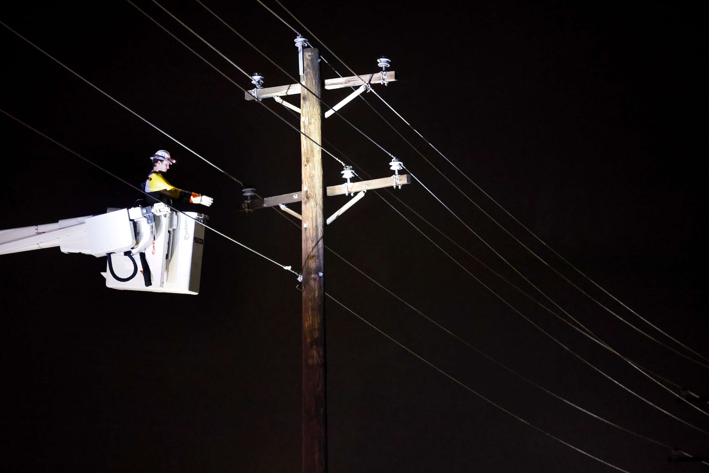 Electrical crews repair a line along Main St in The Colony after a line of thunderstorms...