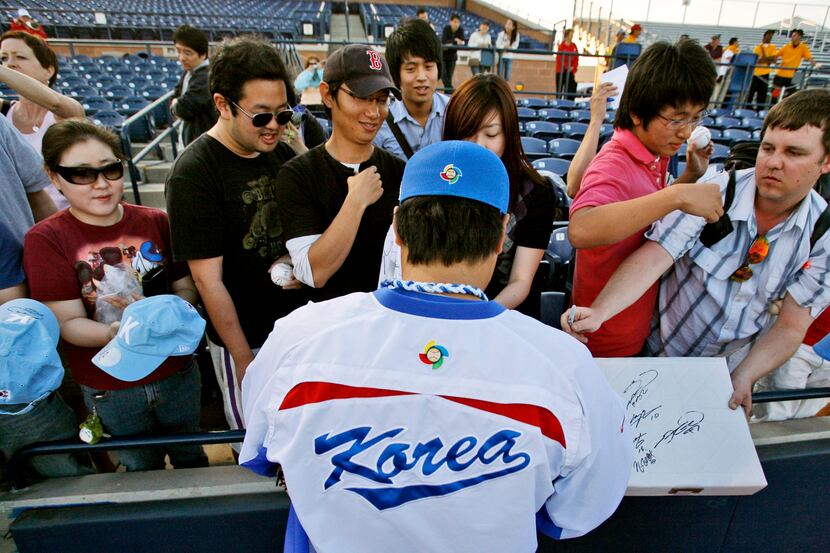 South Korea pitcher Ryu Hyun-jin signs autographs for fans before an exhibition spring...