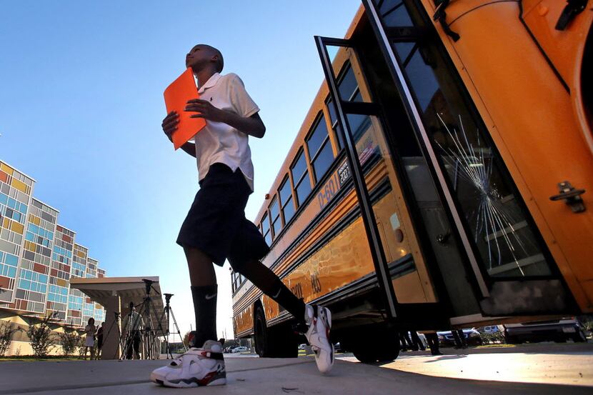 In this 2013 file photo, then-middle-schooler Dorraun Stewart bounds out of the bus to head...
