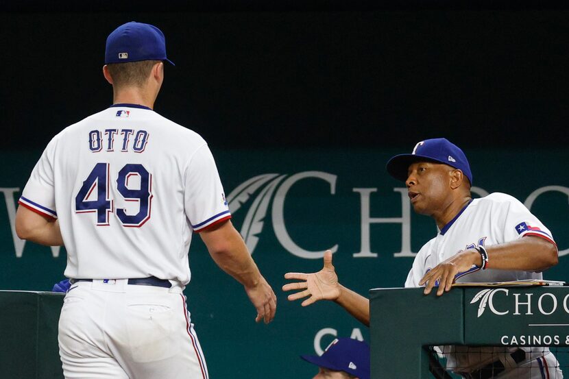 Texas Rangers interim manager Tony Beasley (27) waits to shake starting pitcher Glenn Otto’s...