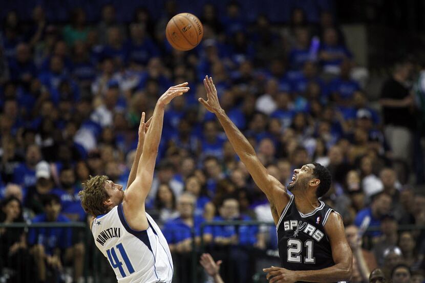 San Antonio Spurs forward Tim Duncan (21) attempts to block a shot by Dallas Mavericks...