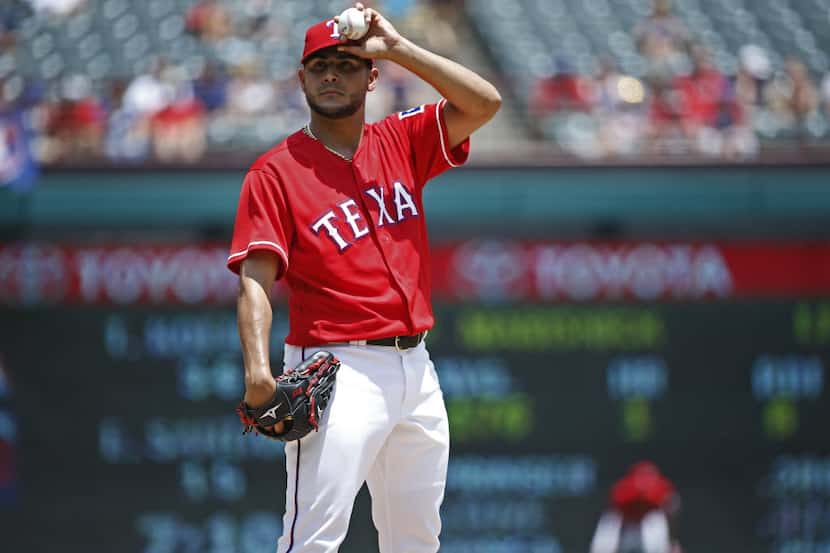 Texas Rangers starting pitcher Martin Perez (33) struggles in the third inning against...