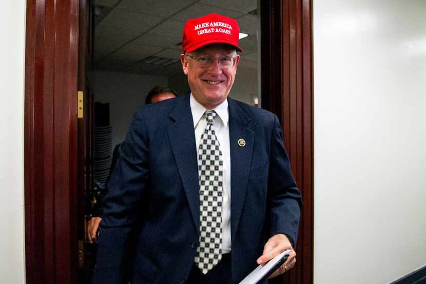 Rep. Mike Conaway, R-Texas, wearing a "Make America Great Again" hat, leaves a House...
