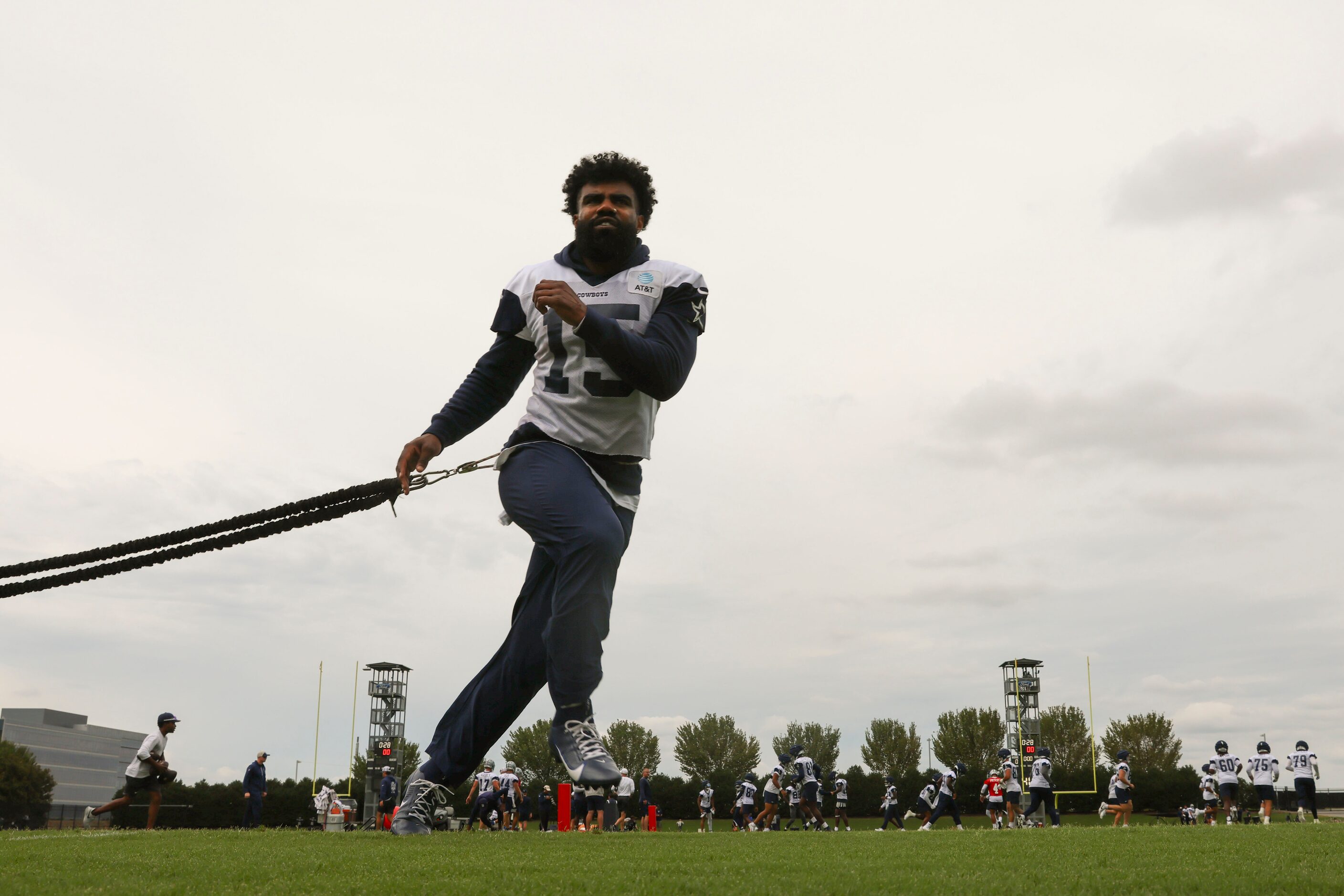 Dallas Cowboys running back Ezekiel Elliott (15) takes part in a drill during a team...