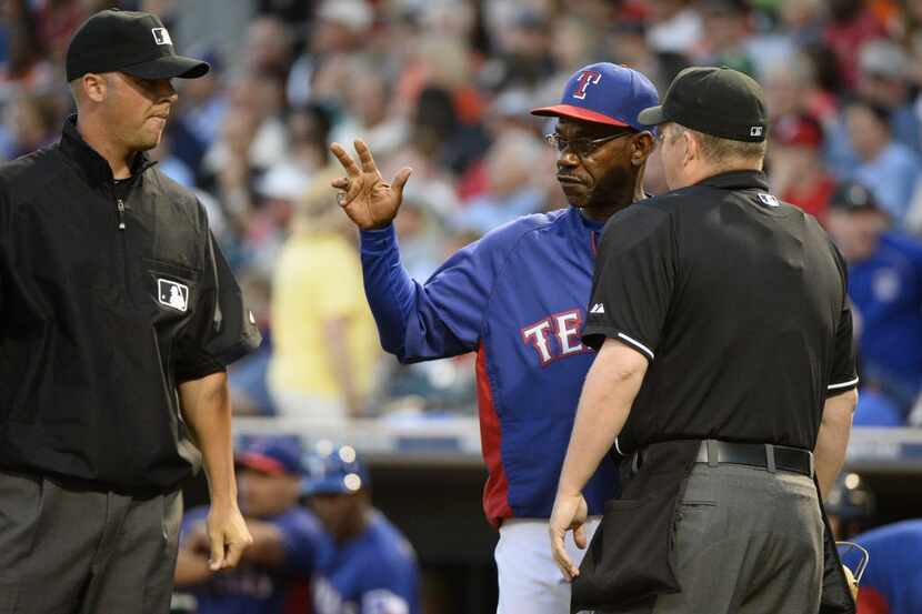 Mar 13, 2014; Surprise, AZ, USA; Texas Rangers manager Ron Washington (center) questions a...