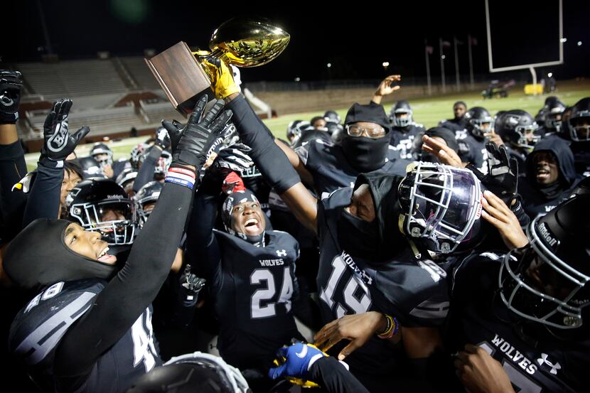 Mansfield Timberview players celebrate their win over Frisco Heritage with the Class 5A...
