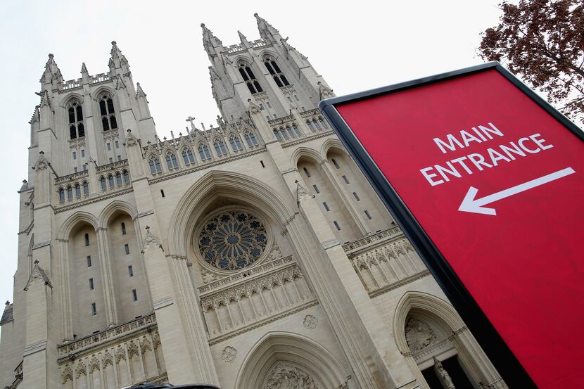 A sign directs visitors to the entrance of the Washington National Cathedral.