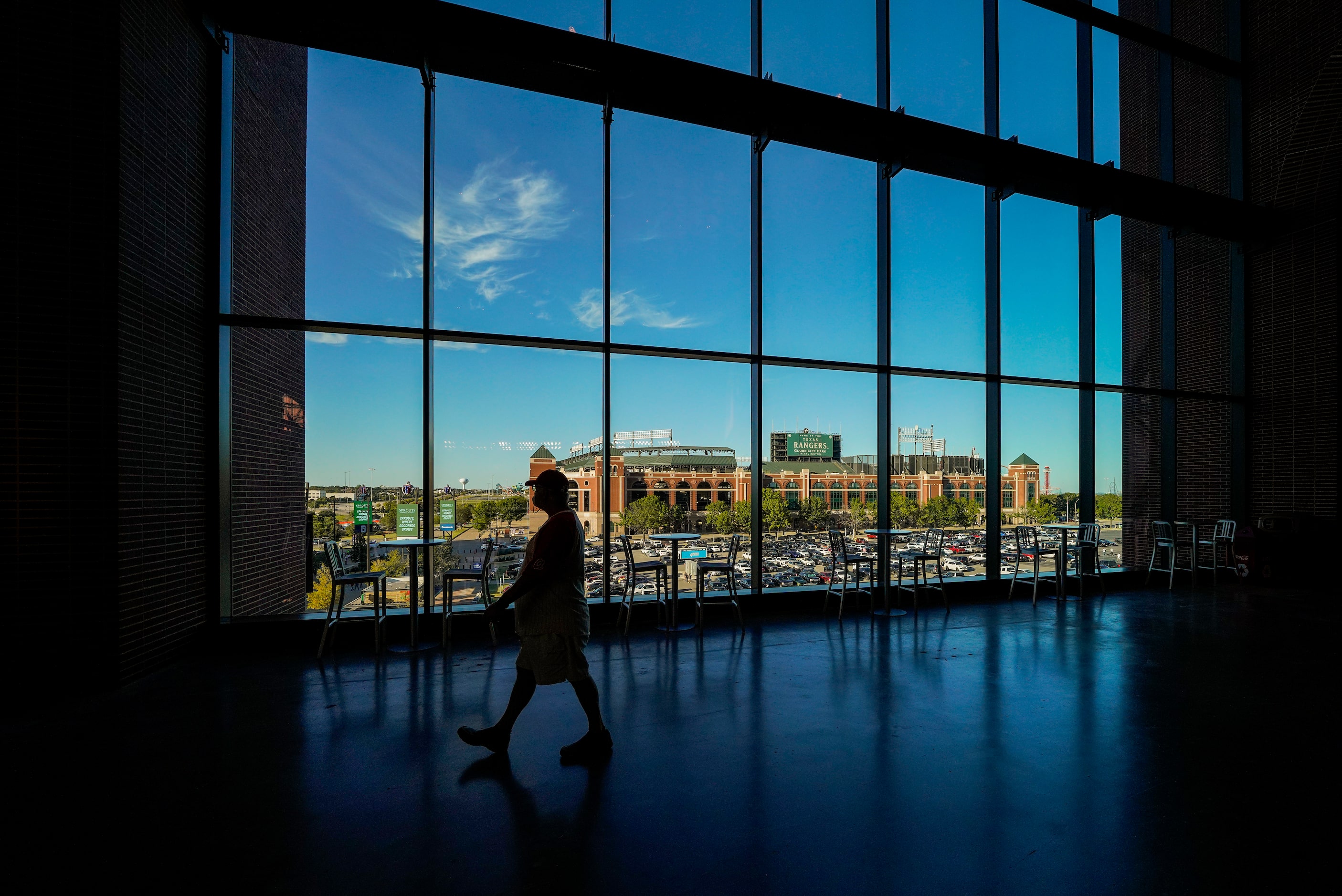 Globe Life Park is seen through the windows as a fan walks the upper concourse before Game 1...