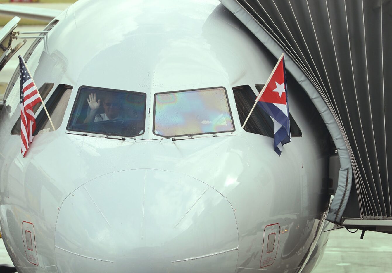 MIAMI, FL - SEPTEMBER 07:  A pilot waves as he prepares to push back from the gate in...