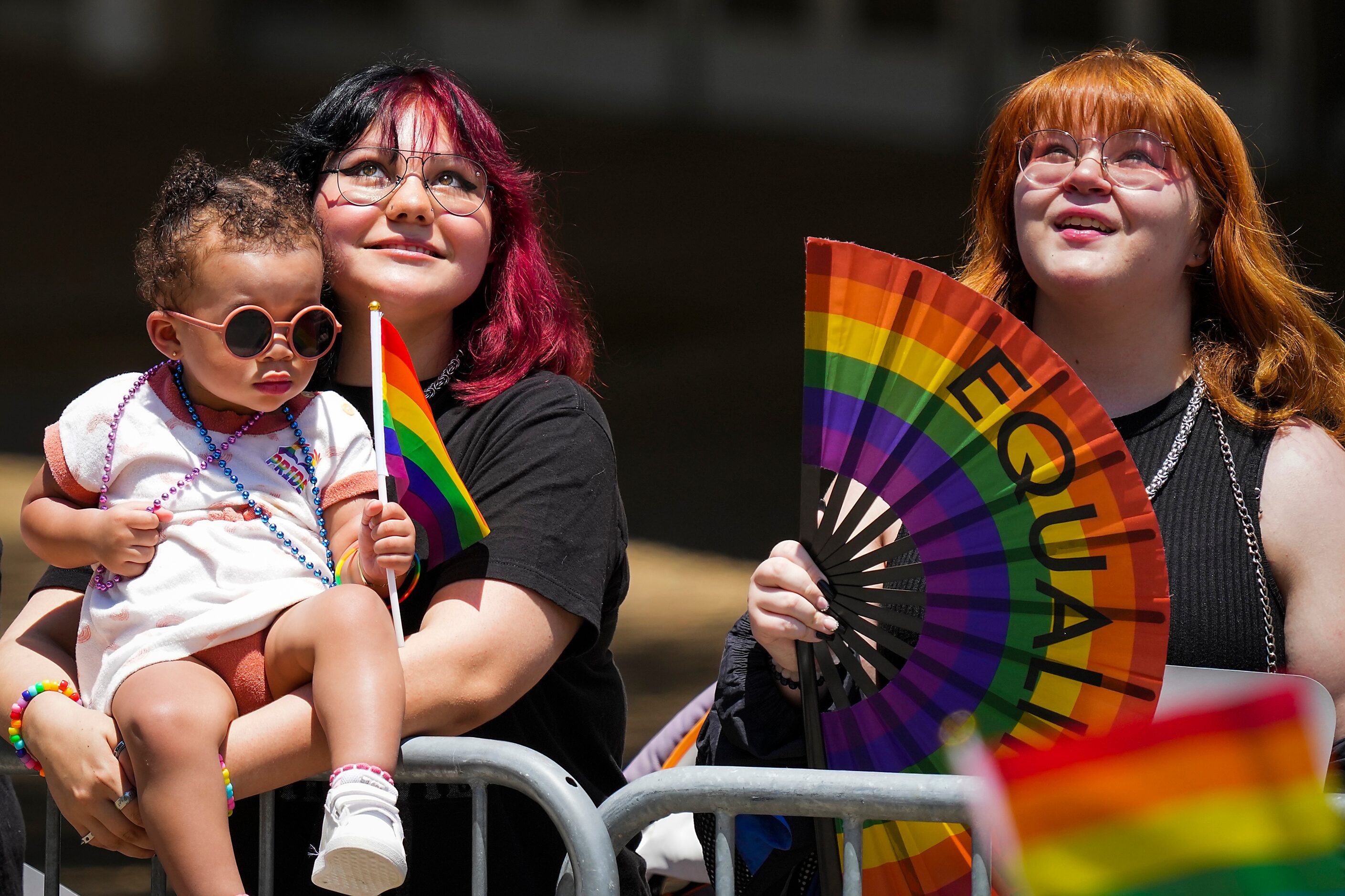 Madison Svitak holds her 18-month old godsister Zaylee Runderson as they watch the annual...