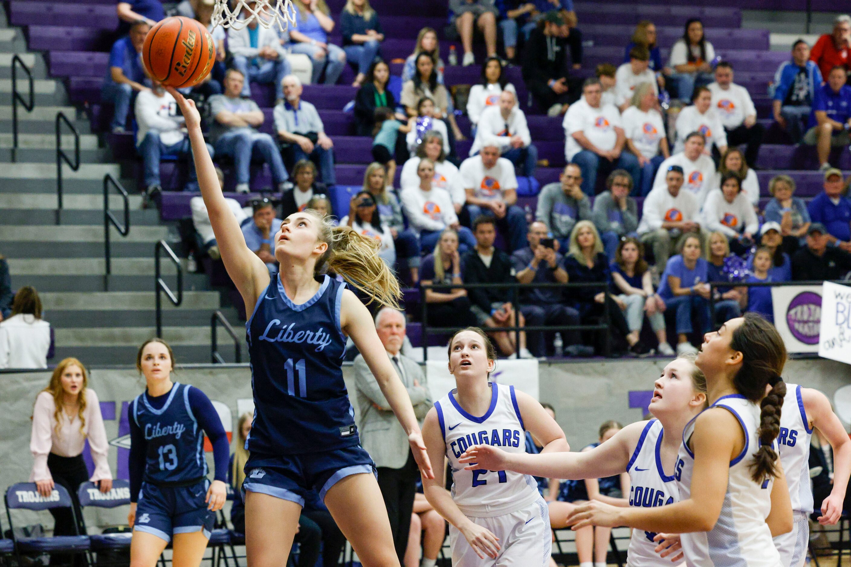 Argyle Liberty Christian guard Lauren Ullrich (11) lays the ball up during the second half...