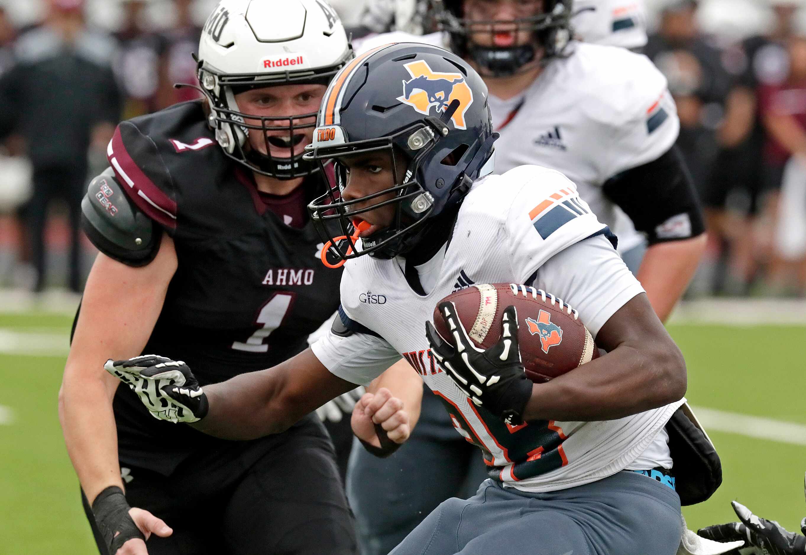 Sachse High School running back Brendon Haygood (28) looks for room to run as Wylie High...