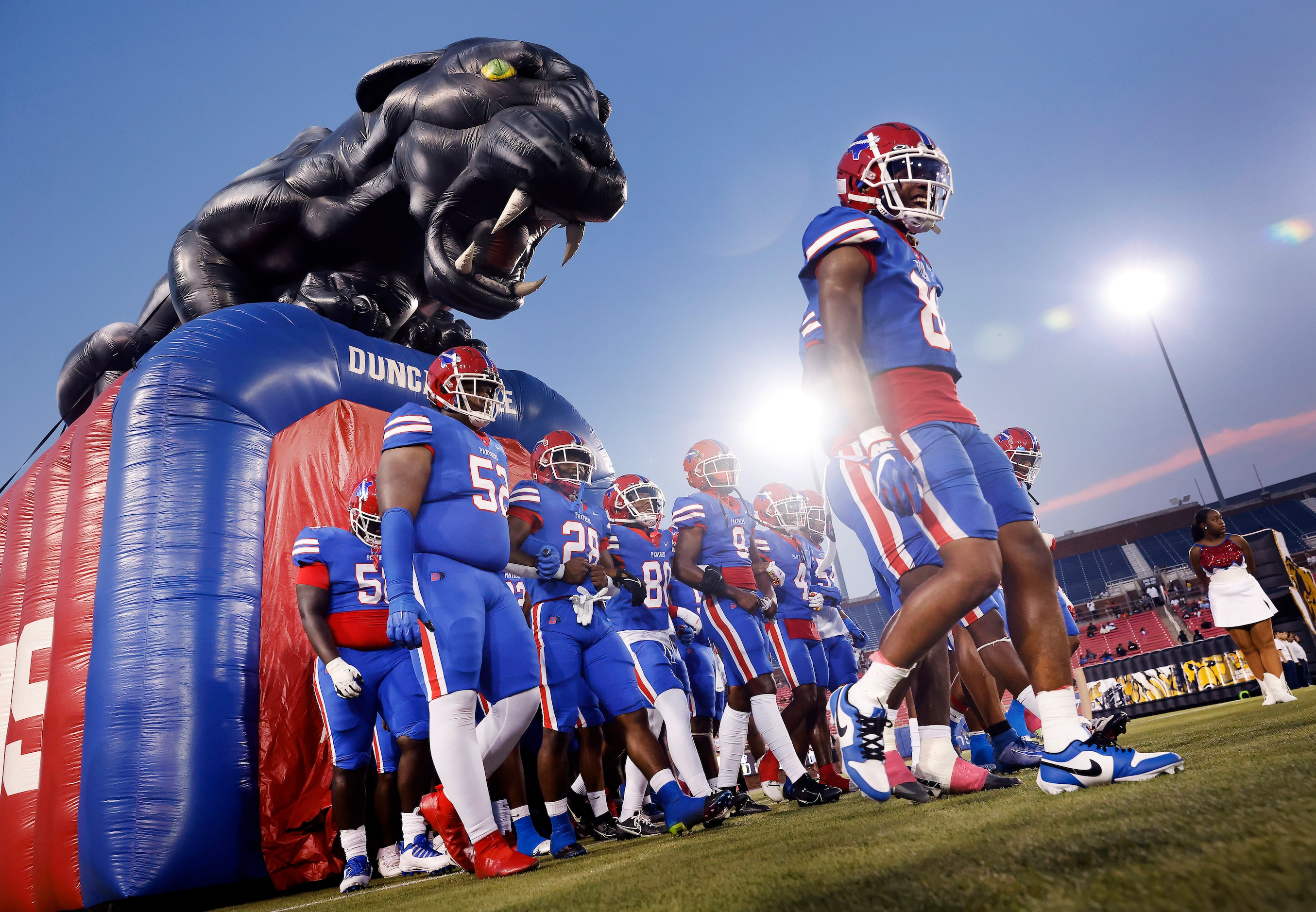 The Duncanville Panthers football team walks in unison onto the field to face South Oak...