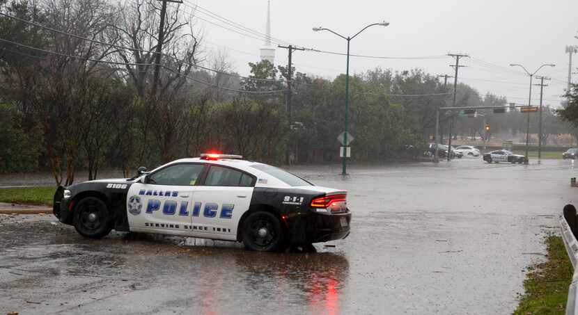 Dallas police shut down Hillcrest Road just south of Royal Lane after heavy rains caused...