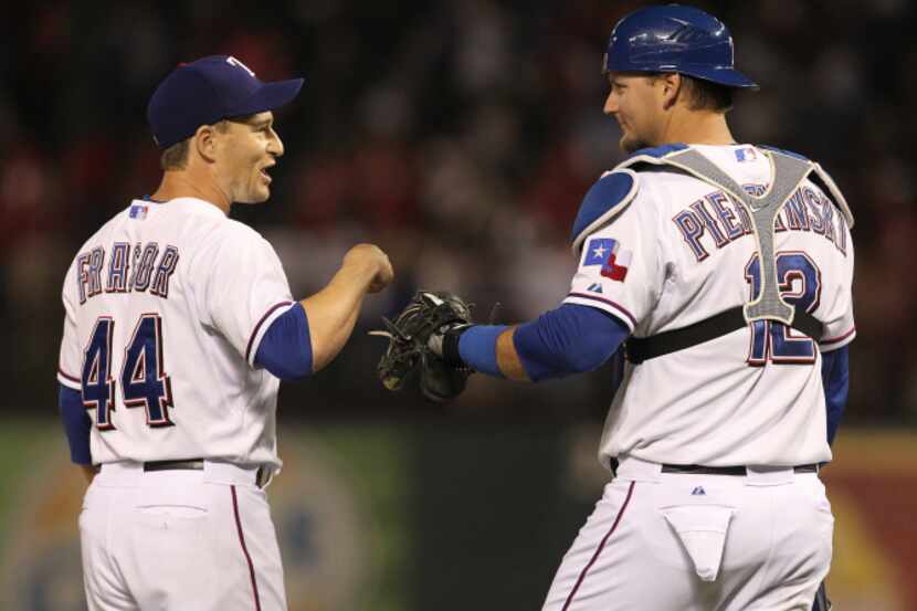 Texas Rangers catcher A.J. Pierzynski (12) congratulates Texas Rangers relief pitcher Jason...