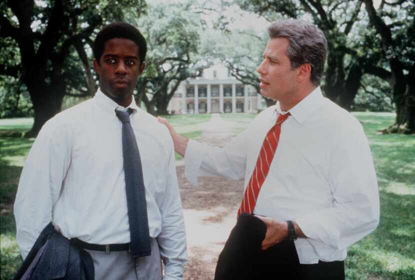Adrian Lester (left) and John Travolta in a scene from "Primary Colors."
