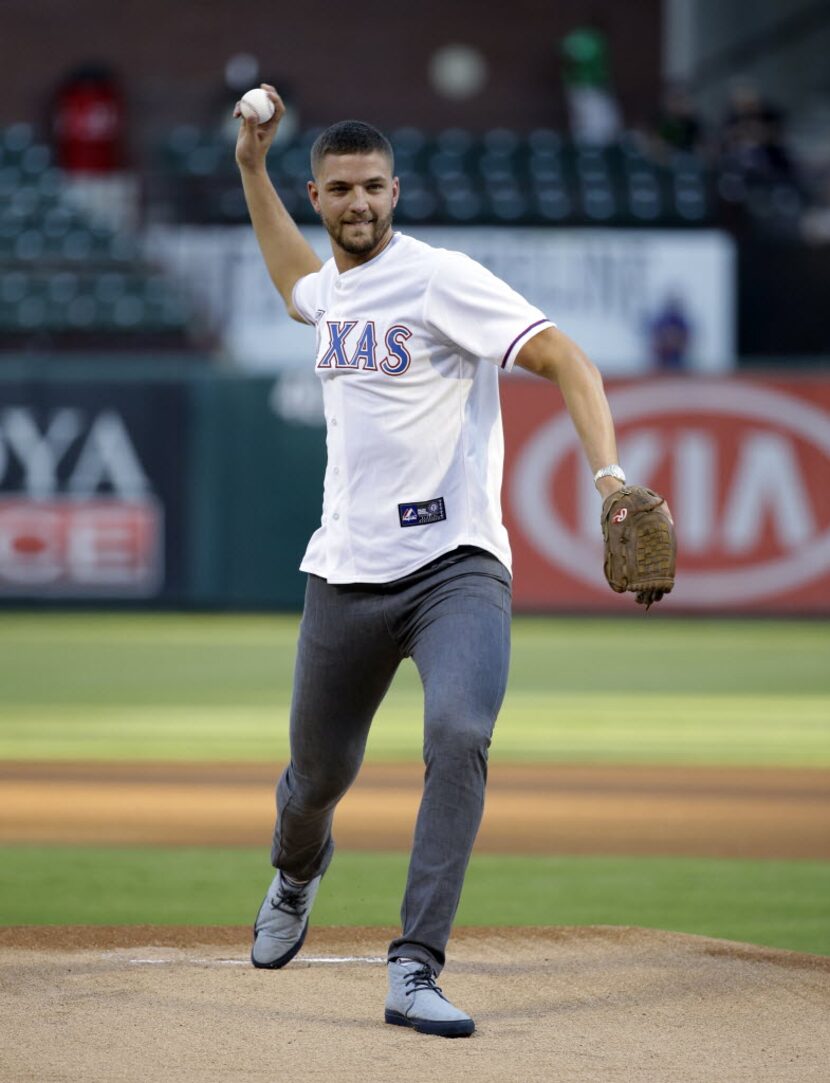 Dallas Mavericks' Chandler Parsons throws out the ceremonial first pitch before a baseball...