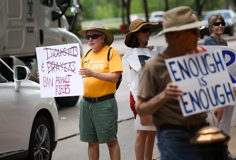 Dave Troiano holds a sign during a rally for stricter gun regulations on Wednesday, June 1,...