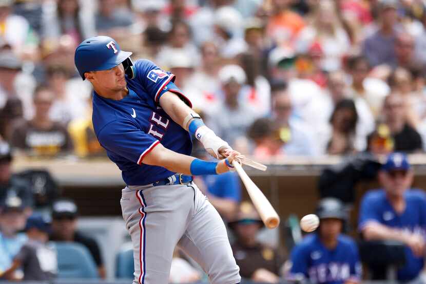 Texas Rangers' Josh Jung breaks his bat on a line drive against the San Diego Padres in the...