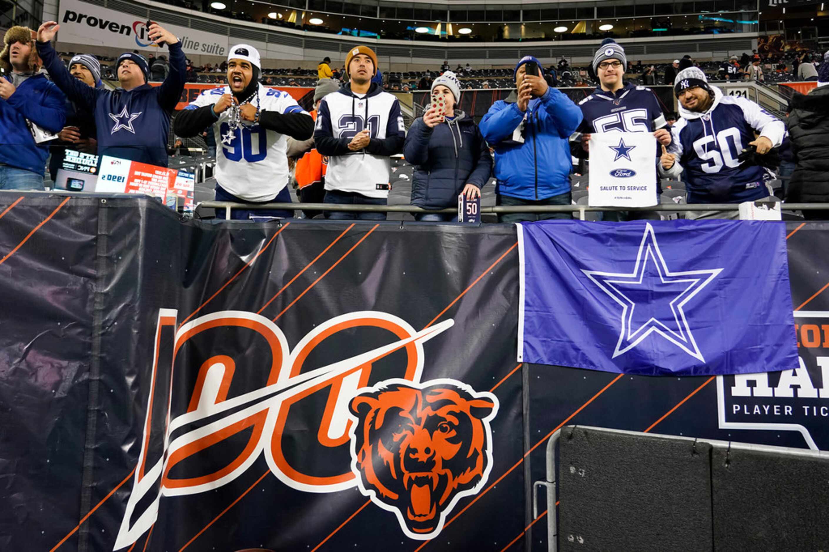 Dallas Cowboys fans cheer their team as they warm up before an NFL football game against the...