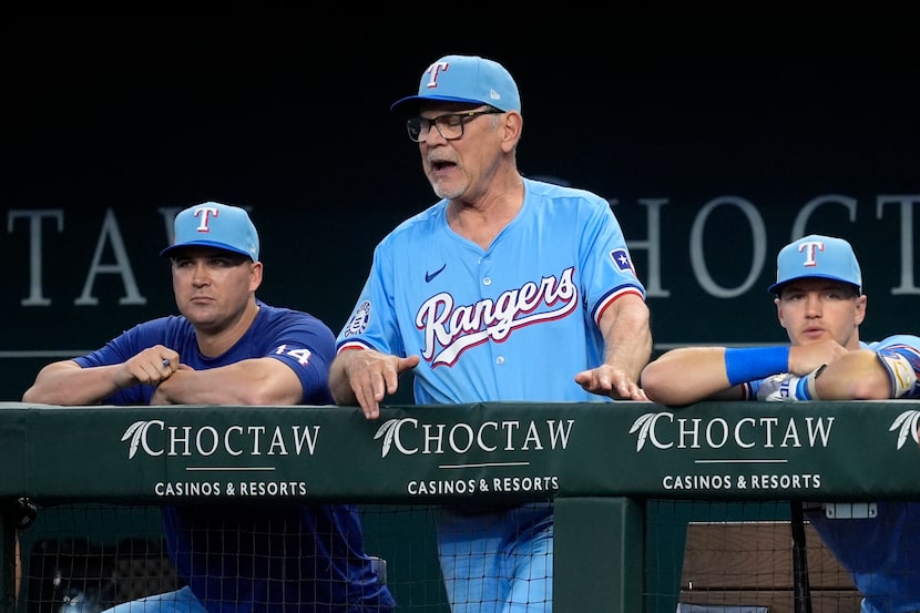 Texas Rangers manager Bruce Bochy (center) reacted during a Corey Seager at-bat as bench...