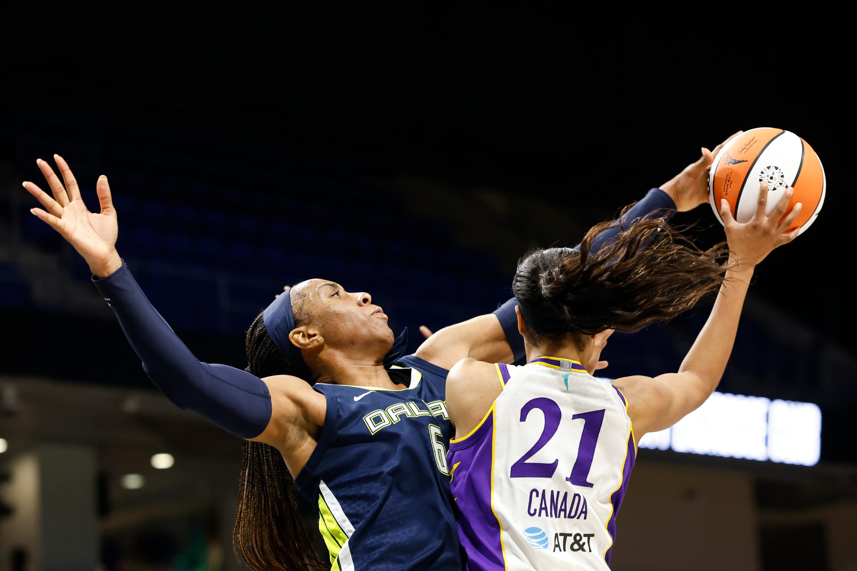 Dallas Wings forward Kayla Thornton, left, blocks a pass of Los Angeles Sparks guard Jordin...