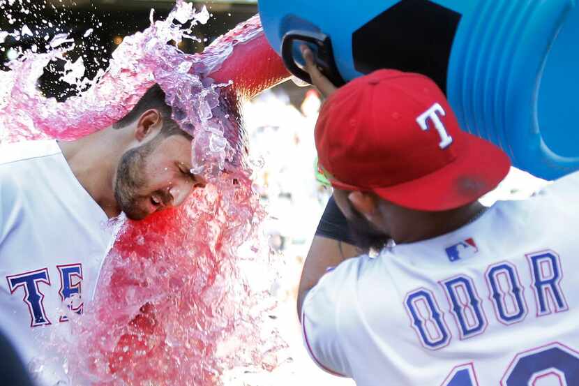 Texas Rangers third baseman Joey Gallo (13) gets a sports drink bath from teammate Rougned...