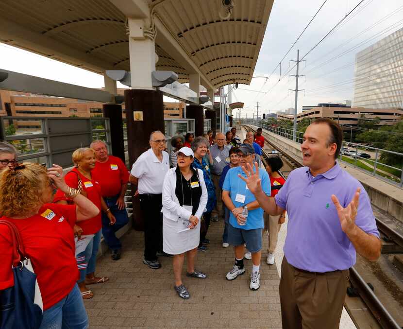 Chris Walters, right , with Community Engagement for DART, explains the safety features at...