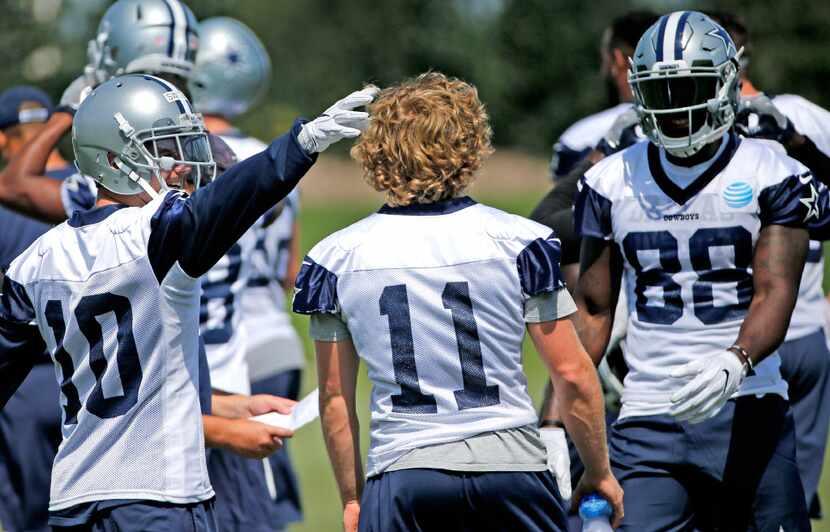 Dallas receiver Ryan Switzer (10) pats fellow receiver Cole Beasley (11) on the head during...
