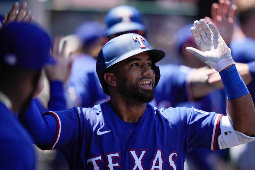 Texas Rangers' Ezequiel Duran celebrates after hitting a home run during the second inning...