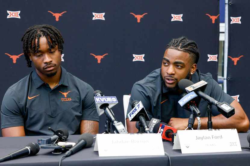 Texas linebacker Jaylan Ford (right) speaks to reporters alongside defensive back Jahdae...