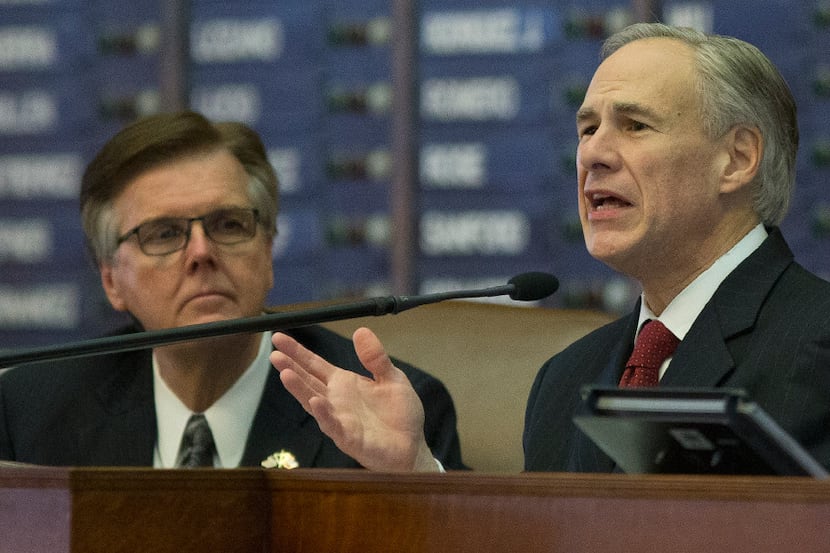 Texas Gov. Greg Abbott, right, delivers his State of the State address to a joint session of...