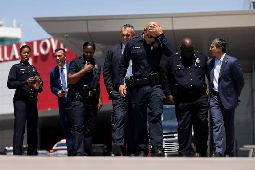 Dallas police Chief Eddie García puts his hand on his head as he walks to talk to the press...