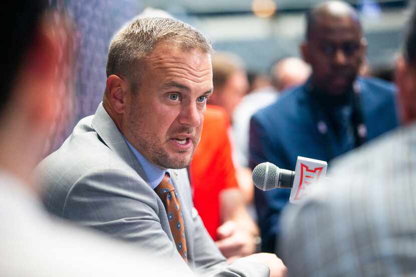 University of Texas head football coach Tom Herman speaks with reporters during the breakout...